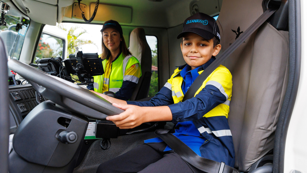 An image of Ethan Nilsen getting safety instructions from Cleanaway garbage truck driver Krystle Tilley.