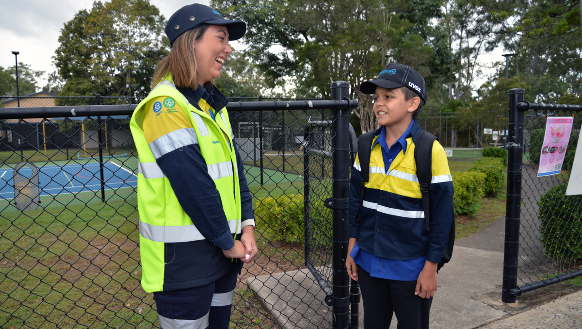 An image of Cleanaway driver Krystle Tilley drops Ethan Nilsen outside Daisy Hill State School.