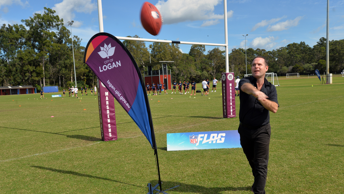 An image of City of Logan Mayor Jon Raven gets a pass away American-style at the NFL Flag trial day at Marsden today.