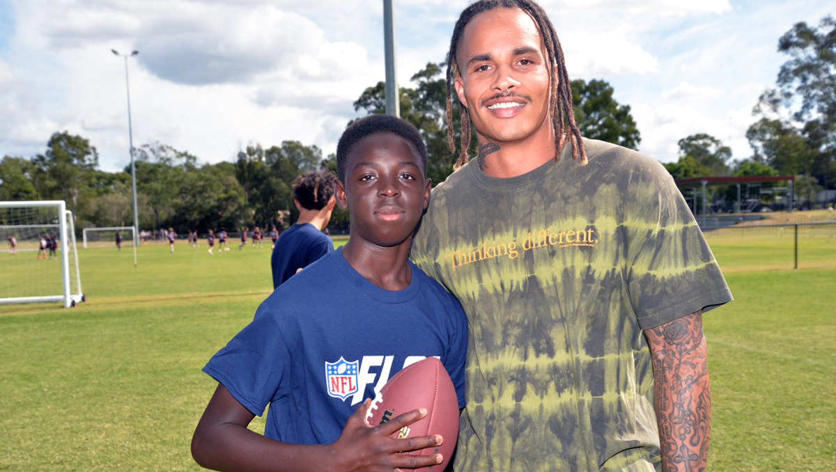 An image of retired NFL player Kenny Stills with Marsden SHS student Amara Sangare, 14, of Pallara.