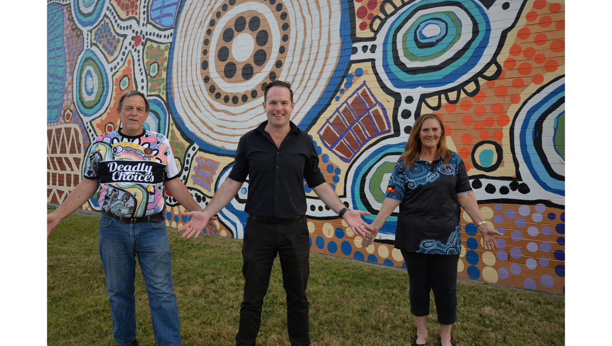 City of Logan Mayor Jon Raven (centre), Uncle Terry Stedman (left) and Aunty Sheryl Banks from the Logan District Aboriginal & Torres Strait Islander Corporation for Elders invite the community to join in NAIDOC Day 2024 celebrations.