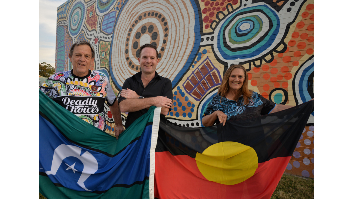 City of Logan Mayor Jon Raven (centre) and Uncle Terry Stedman (left) and Aunty Sheryl Banks from the Logan District Aboriginal & Torres Strait Islander Corporation for Elders are flying the flag for NAIDOC Week 2024.