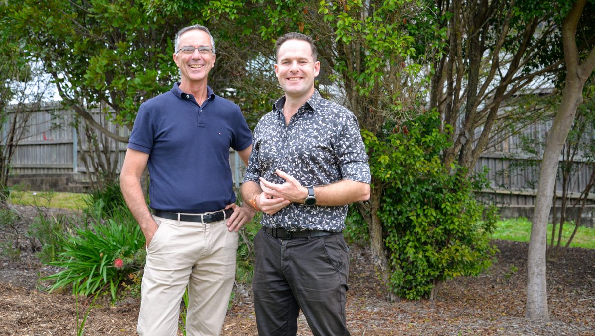 Mayor Jon Raven (right) and Division 5 Councillor Paul Jackson in front of a new buffer garden planted to protect one of the area’s endangered Gossia gonoclada trees.