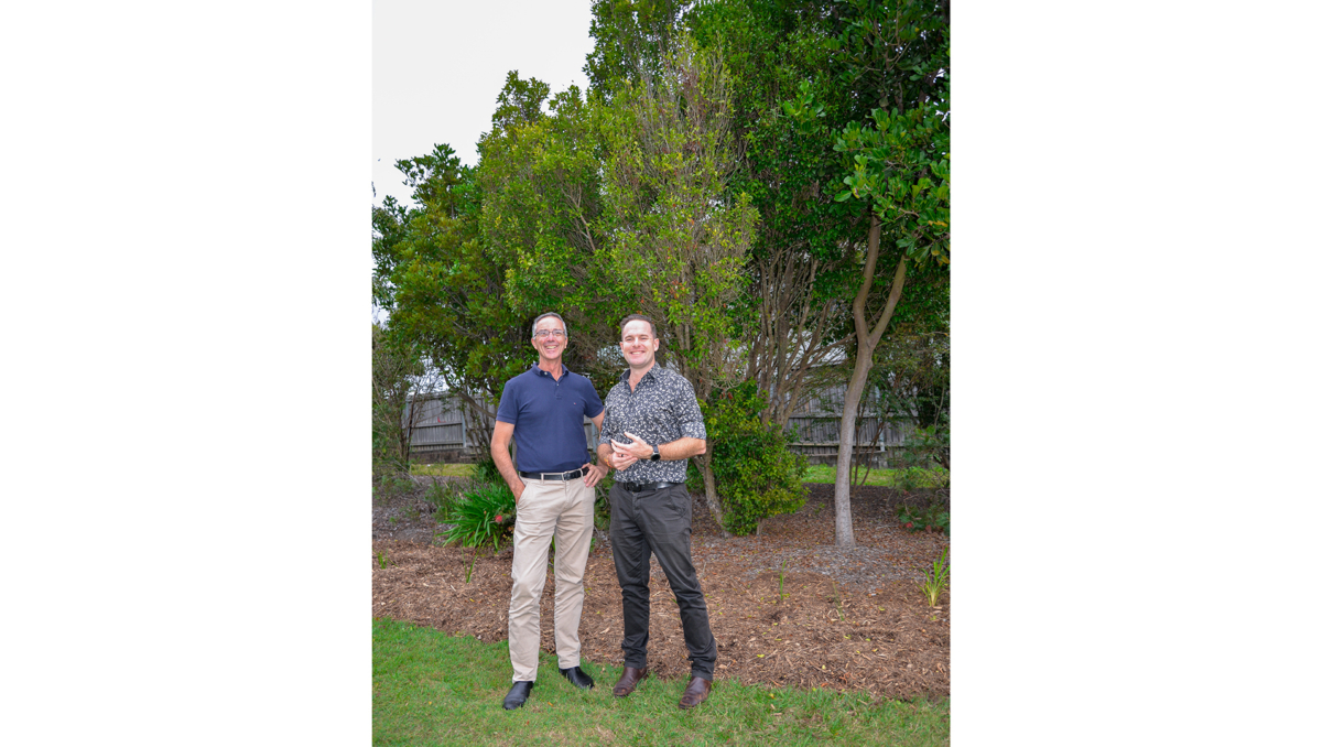 Mayor Jon Raven (right) and Division 5 Councillor Paul Jackson in front of a new buffer garden planted to protect one of the area’s endangered Gossia gonoclada trees.