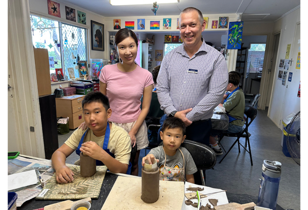 aN IMAGE OF Cr Tim Frazer with Mary Jou and her sons Marco (left) and Jorco at a KRANK school holiday clay-modelling course at the Logan West Community Art Share Alliance Inc at Hillcrest.
