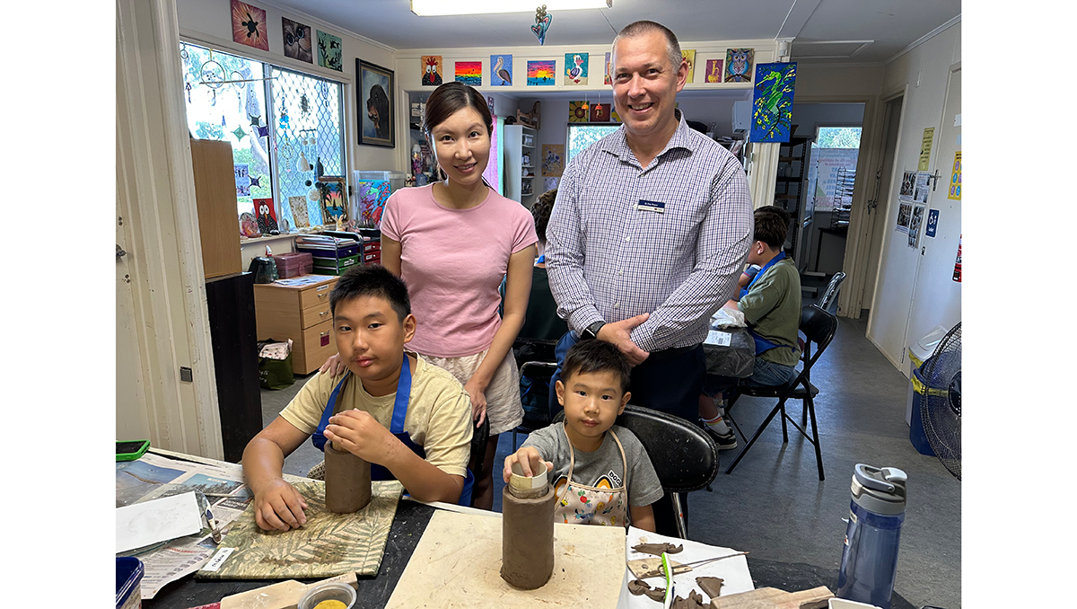 aN IMAGE OF Cr Tim Frazer with Mary Jou and her sons Marco (left) and Jorco at a KRANK school holiday clay-modelling course at the Logan West Community Art Share Alliance Inc at Hillcrest.