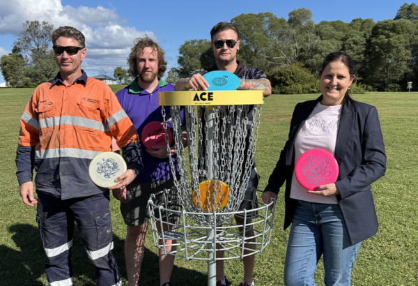 An image of Cr Willcocks at the Logan West Parklands disc golf course with Rhys, Alex and Bendle.
