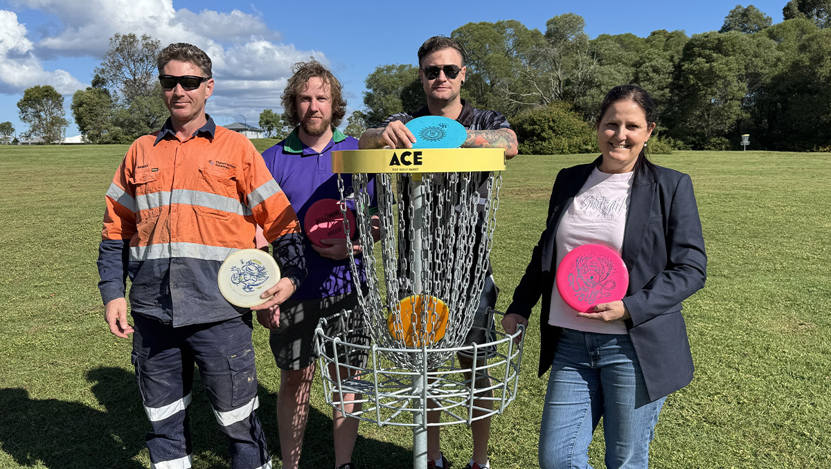 An image of Cr Willcocks at the Logan West Parklands disc golf course with Rhys, Alex and Bendle.
