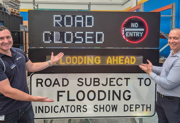An image of Councillors Tony Hall (left) and Tim Frazer (from Division 7) inspect an emergency road sign that is powered by recycled e-waste constructed by Substation33.