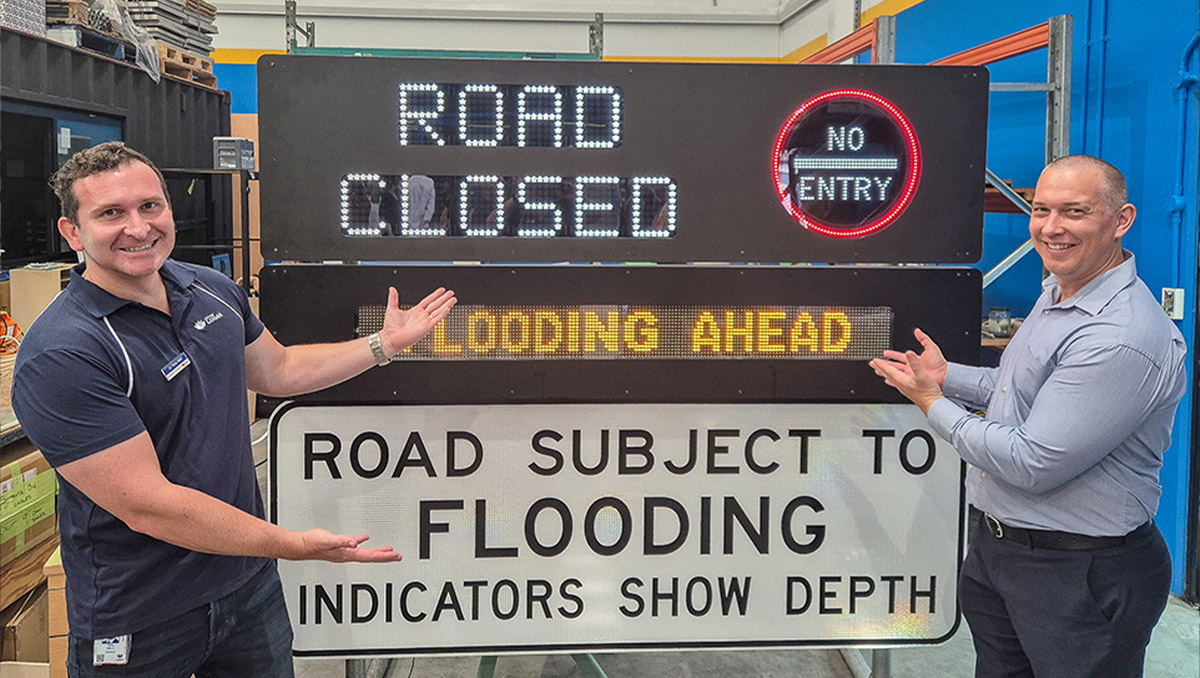 An image of Councillors Tony Hall (left) and Tim Frazer (from Division 7) inspect an emergency road sign that is powered by recycled e-waste constructed by Substation33.