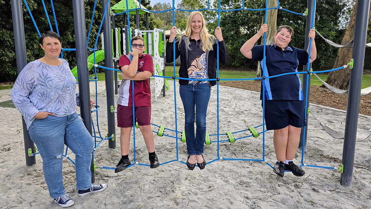 An image of Cr Miriam Stemp (centre) trying out the new playground equipment in Concorde Park with local resident Maria Watson and her sons Zac (left) and Lucas.