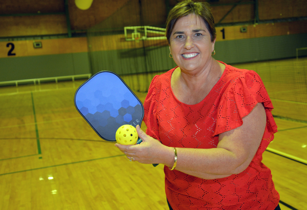 An image of Cr Karen Murphy getting ready to try pickleball at Mount Warren Sports and Fitness Centre.