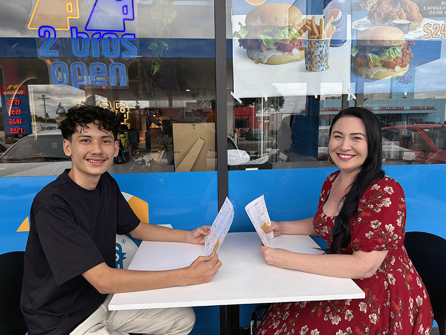 An image of Cr Mindy Russell catches up with former Mabel Park State High student and young entrepreneur Mo Alizadeh at 2 Bros cafe at Slacks Creek.