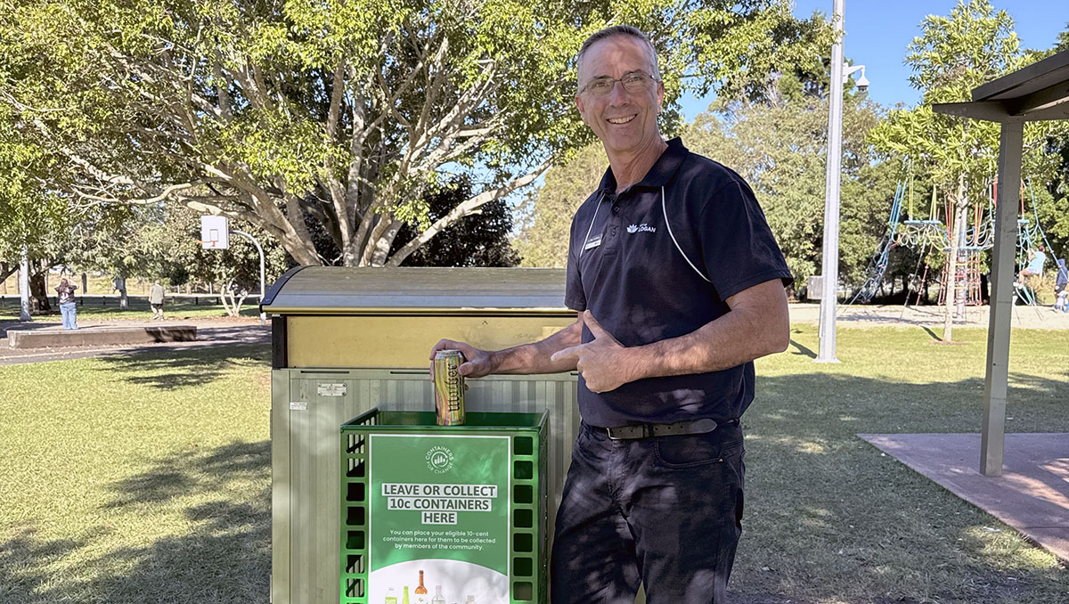 An image of Cr Paul Jackson using one of the Containers for Change baskets in Tygum Park in Waterford West.