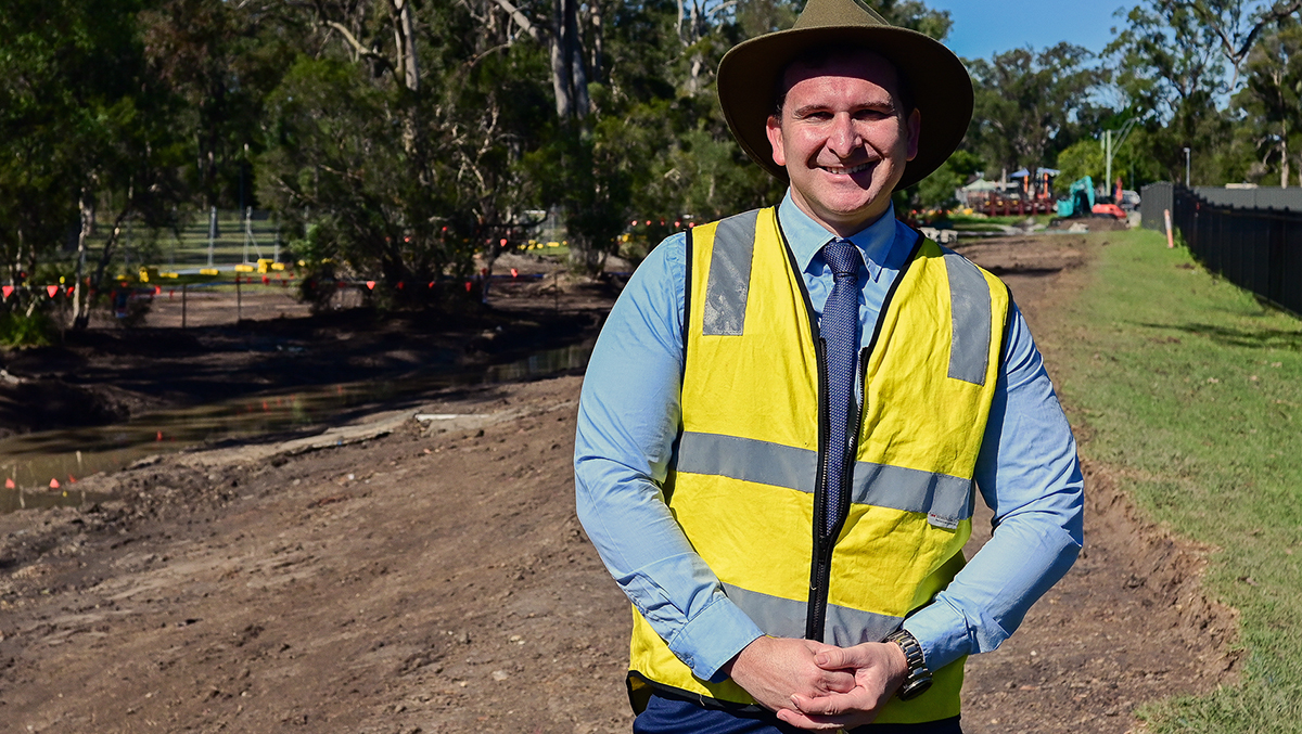 aN IMAGE OF Cr Tony Hall inspectING the start of works on the Sturdee Park drain naturalisation project in Loganlea.
