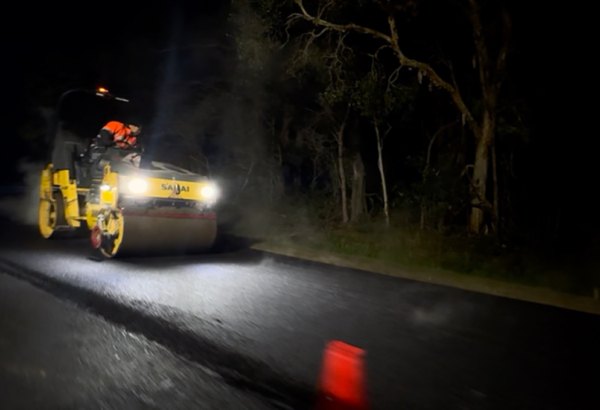 An image of road patching underway at night on School Road at Logan Reserve