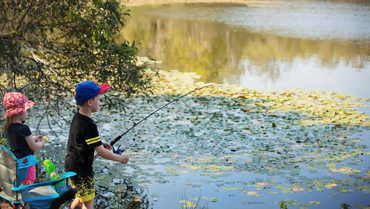 Children fishing in a river