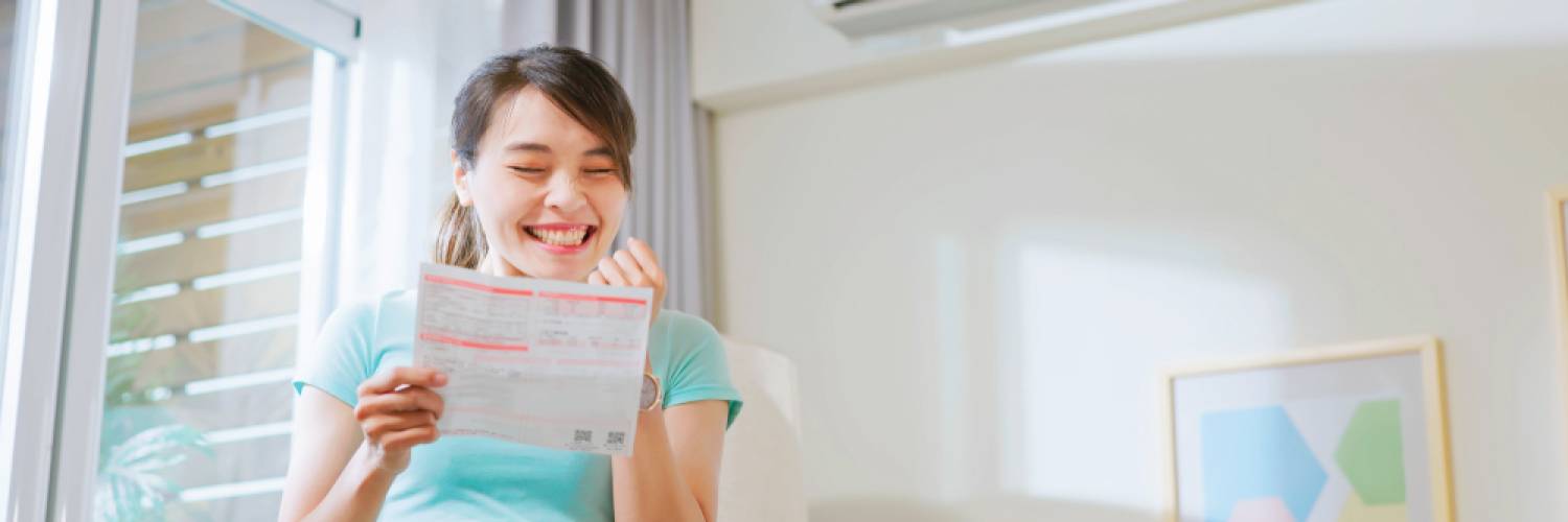 Woman smiling while looking at power bill