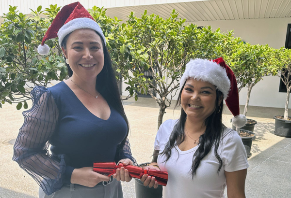 Cr Mindy Russell (left) and Hope Centre's Melly Possumah get into the Christmas spirit. An image of Cr Mindy Russell (left) and Hope Centre's Melly Possumah getting into the Christmas spirit with a bon bons