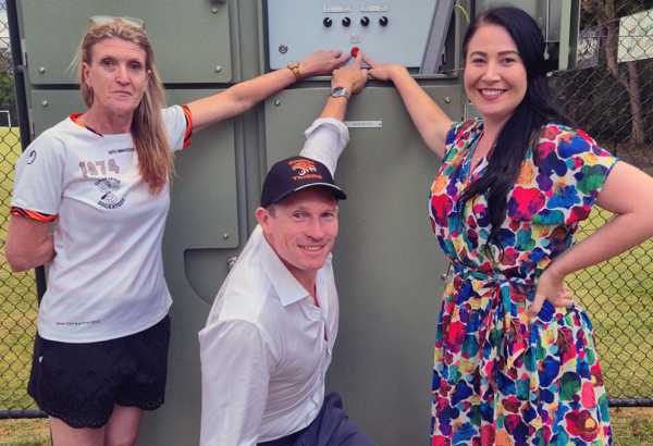 An image of Cr Mindy Russell (right) turning on the new hi-tech lights at Slacks Creek Tigers’ Usher Park headquarters with club vice-president Melissa Cameron and State Member for Springwood, Mick De Brenni.