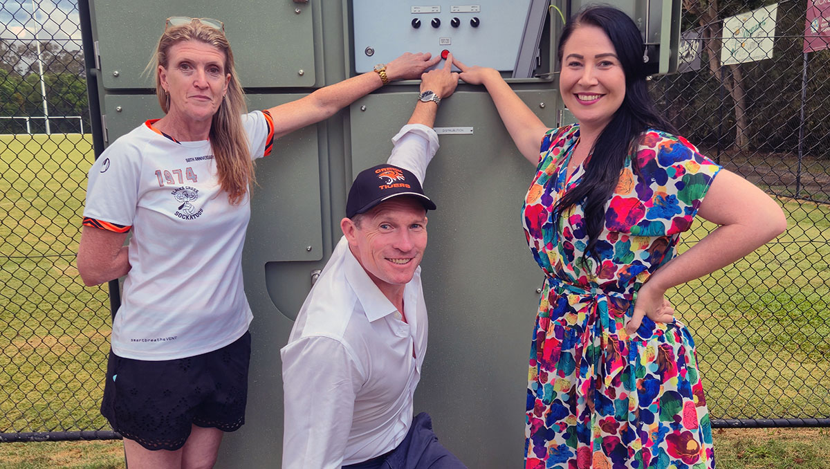An image of Cr Mindy Russell (right) turning on the new hi-tech lights at Slacks Creek Tigers’ Usher Park headquarters with club vice-president Melissa Cameron and State Member for Springwood, Mick De Brenni.