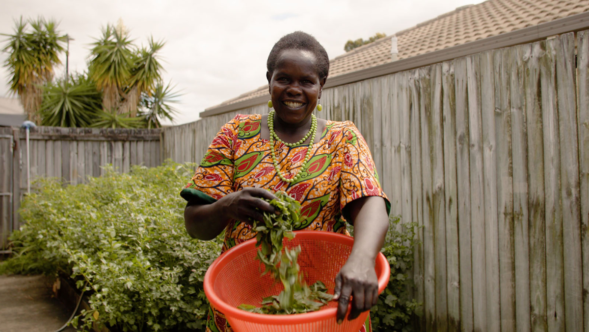 Cecilia Ossa standing outside with a large bowl of vegetables