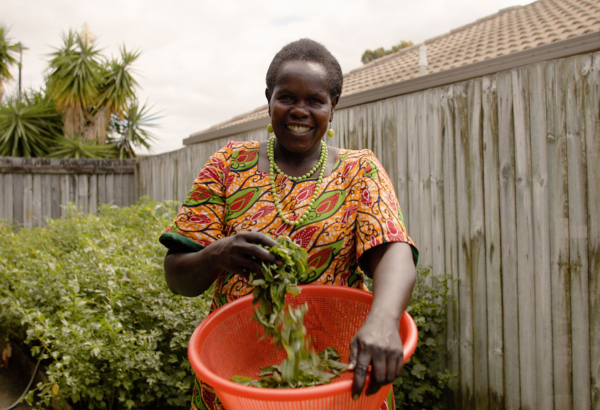 Cecilia Ossa standing outside with a large bowl of vegetables