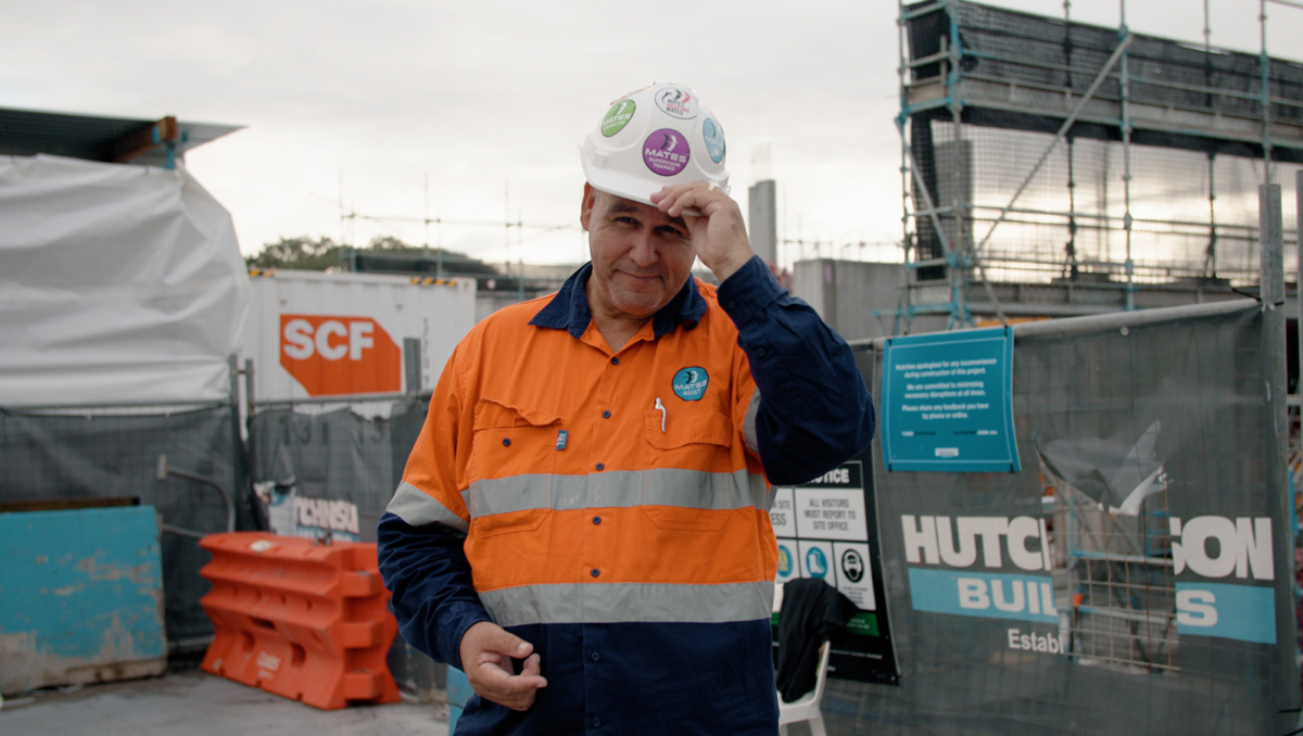 Justin Grange dressed in high vis visits a work site