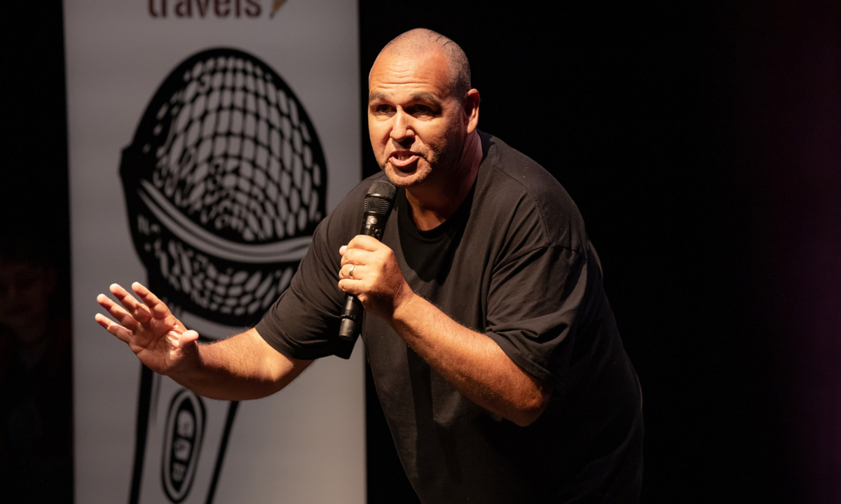 Justin Grange speaking on stage